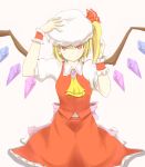  1girl ascot blonde_hair bow brooch colored_eyelashes crystal dress fang_out flandre_scarlet hair_bow hand_on_headwear hat highres jewelry looking_at_viewer mob_cap red_dress red_skirt short_hair side_ponytail skirt skirt_set smile solo touhou tsutsunuke wings wrist_cuffs 