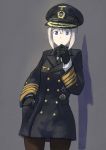  1girl :&lt; against_wall black_legwear blonde_hair coat cowboy_shot erica_(naze1940) female_admiral_(kantai_collection) gloves hand_in_pocket hand_on_own_chin hat highres iron_cross kantai_collection medal military military_uniform naval_uniform necktie pantyhose shadow short_hair simple_background solo uniform violet_eyes visor_cap world_war_ii 