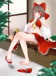  1girl arm_support ascot blurry bow brown_eyes clothes_in_front depth_of_field detached_sleeves eating feet hair_bow hair_tubes hakurei_reimu hand_to_own_mouth highres indoors kozue_akari looking_at_viewer midriff navel plant sandals sitting skirt skirt_removed solo touhou window 