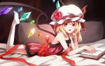  1girl asymmetrical_hair bare_arms bare_shoulders book bow collarbone fang flandre_scarlet flower hat hat_bow hat_flower highres leg_up looking_at_viewer lying mob_cap nightgown on_stomach open_mouth pillow rain_(icetuofei) red_eyes red_rose ribbon rose side_ponytail smile solo thigh-highs touhou white_legwear wings zettai_ryouiki 