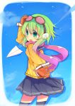  1girl :d brown_gloves fang gloves goggles goggles_on_head green_eyes green_hair gumi hand_on_head headphones highres looking_at_viewer open_mouth paper_airplane pleated_skirt rowtan scarf school_uniform serafuku short_hair skirt smile solo vocaloid 