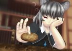  1girl :3 animal_ears blurry bookshelf capelet cookie depth_of_field dutch_angle elbow_rest food foreshortening giving grey_hair head_rest highres jewelry looking_at_viewer mouse_ears nazrin one_eye_closed pendant red_eyes short_hair smile solo table touhou yuuzaa-mei 