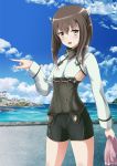  1girl bike_shorts blush brown_hair clouds dock flat_chest headgear highres inoshira kantai_collection long_hair looking_at_viewer open_mouth pointing sky solo standing taihou_(kantai_collection) yellow_eyes 