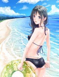  1girl adjusting_clothes adjusting_swimsuit ass back beach bikini black_eyes black_hair clouds earrings highres innertube jewelry kinoebi ocean original sand sky solo standing swimsuit water wet 