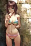  1girl against_wall arm_behind_back bare_shoulders bikini blue_eyes blush breasts brick_wall brown_hair candy collarbone cowboy_shot guchico holding lollipop navel original short_hair smile solo standing swimsuit 
