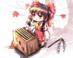  1girl ascot autumn autumn_leaves bow box brown_eyes brown_hair check_commentary child commentary_request detached_sleeves donation_box dress gohei hair_bow hair_tubes hakurei_reimu kotou_(ko-tou) long_sleeves open_mouth red_dress solo touhou wide_sleeves younger 