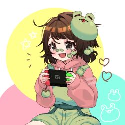  1girl :d absurdres animal_print bandaid bandaid_on_face bandaid_on_nose bethy black_eyes blush brown_hair charm_(object) commentary_request commission commissioner_upload cowboy_shot english_commentary eyelashes frog_charm frog_hair_ornament frog_mask frog_print green_bandaid green_overalls hair_ornament handheld_game_console heart highres holding holding_handheld_game_console hood hood_down hoodie indie_virtual_youtuber long_sleeves looking_at_object mask mask_on_head medium_hair mixed-language_commentary mst2020 nintendo_switch open_mouth overalls pink_hoodie playing_games short_twintails sitting sleeves_past_wrists smile solo star_(symbol) sticker_on_face tomboy tongue twintails virtual_youtuber white_background yellow_circle 