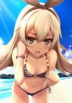  1girl bare_shoulders beach bikini blonde_hair blue_sky blush bow bracelet fang green_eyes hair_bow hairband jewelry kantai_collection leaning_forward long_hair looking_at_viewer navel open_mouth rods shimakaze_(kantai_collection) side-tie_bikini sky solo sunlight swimsuit 