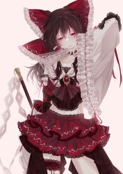  1girl absurdres adapted_costume ascot between_fingers bow brown_hair commentary detached_sleeves english_commentary frilled_bow frilled_hair_tubes frills gohei hair_bow hair_tubes hakurei_reimu highres holding holding_gohei holding_ofuda lace-trimmed_skirt lace-trimmed_thigh_strap lace_trim long_hair looking_at_viewer midriff navel ofuda ofuda_between_fingers pink_background red_bow red_eyes red_skirt ribbon-trimmed_sleeves ribbon_trim simple_background skirt skirt_set solo thigh_strap touhou yodaka_(hsytk12) 
