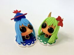  2girls blue_dress blue_hair blue_hat chibi chibi_only commentary_request dress dual_persona ex-keine facing_ahead figure_(medium) full_body green_dress green_hair hat highres horn_ornament horn_ribbon horns kamishirasawa_keine long_hair multiple_girls neckerchief neriko_nerineri no_mouth photo_(medium) puffy_short_sleeves puffy_sleeves red_neckerchief ribbon short_sleeves solid_eyes touhou v_arms 