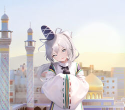  absurdres black_hat city commentary grey_eyes grey_hair guilty_merlin hat head_tilt highres long_hair looking_at_viewer middle_eastern_architecture mononobe_no_futo outdoors pom_pom_(clothes) ponytail ribbon-trimmed_sleeves ribbon_trim sky smile tate_eboshi touhou upper_body wide_sleeves 