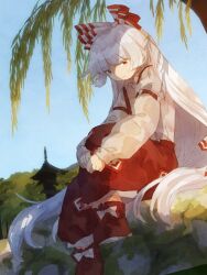  1girl baggy_pants blue_sky bow clear_sky closed_mouth commentary_request day footwear_bow fujiwara_no_mokou full_body hair_bow hair_flowing_over hugging_own_leg long_hair long_sleeves looking_at_viewer moss multiple_hair_bows ofuda ofuda_on_clothes outdoors pants red_eyes red_pants red_shoes retrochaossan shirt shoes sitting sky solo temple touhou tree very_long_hair white_hair white_shirt 