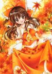  1girl ahoge ascot autumn autumn_leaves bare_shoulders bow breasts brown_eyes brown_hair bust collarbone detached_sleeves fingernails hair_bow hair_tubes hakurei_reimu highres izumo_neko looking_at_viewer midriff navel open_mouth outdoors red_nails ribbon-trimmed_sleeves ribbon_trim skirt skirt_hold smile solo touhou wide_sleeves 