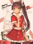  1girl black_legwear blush brown_eyes brown_hair christmas_tree cowboy_shot dated fur_trim gift houshou_(kantai_collection) kantai_collection long_hair looking_away merry_christmas romshiro santa_costume short_sleeves solo twitter_username 