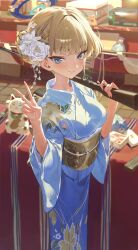  absurdres bag blonde_hair blue_archive blue_eyes blue_halo blue_kimono blue_streaks blurry blurry_background blush box breasts cat commentary dance_arm depth_of_field festival floral_print floral_print_kimono flower flower_request gun hair_bun hair_flower hair_intakes hair_ornament halo highres holding holding_gun holding_weapon japanese_clothes kimono looking_at_viewer maneki-neko multicolored_hair obi print_kimono rifle sash short_hair small_breasts smile standing stone_floor streaked_hair swept_bangs table toki_(blue_archive) v weapon white_flower yukata 