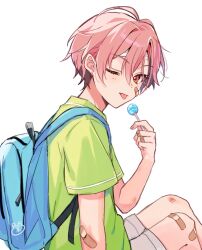  1boy backpack bag bandaid bandaid_on_arm bandaid_on_cheek bandaid_on_face bandaid_on_knee bandaid_on_leg candy closed_mouth ensemble_stars! food green_shirt hair_between_eyes highres holding holding_candy holding_food holding_lollipop kuon_mashu lollipop looking_at_viewer male_focus one_eye_closed pink_hair red_eyes shirt short_hair short_sleeves simple_background solo tamano_mayo tongue tongue_out white_background 
