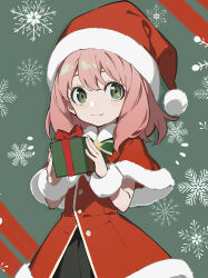  1girl absurdres anya_(spy_x_family) bow bowtie capelet christmas christmas_present commentary_request cowboy_shot dot_nose dress gift green_background green_bow green_bowtie green_eyes hair_between_eyes hat hatsutahaku highres holding holding_gift light_smile long_hair looking_at_viewer pink_hair red_background red_capelet santa_costume santa_dress santa_hat simple_background snowflake_print solo spy_x_family standing two-tone_background 