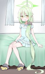  1girl bed blue_archive blue_pajamas blush commentary_request cup curtains green_hair green_halo hair_down hair_ornament hair_scrunchie halo highres knees_together_feet_apart long_hair low_side_ponytail missing_tail mmisodaizu03 nightgown nozomi_(blue_archive) nozomi_(kujibikido)_(blue_archive) official_alternate_costume on_bed pajamas pointy_ears scrunchie side_ponytail sitting slippers solo window yellow_eyes 
