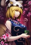  1girl blonde_hair breasts bust cherry_blossoms cup flower fox_tail hat hat_with_ears holding large_breasts light_smile lips looking_at_viewer mob_cap multiple_tails short_hair side_glance sleeveless slit_pupils solo steam tabard tail teacup touhou tree_branch watermark xiaoyin_li yakumo_ran yellow_eyes 