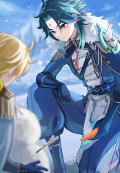  2boys aether_(genshin_impact) ahoge armor blonde_hair blue_gloves blue_pants blurry blurry_background blurry_foreground building_snowman carrot commentary_request epaulettes facial_mark forehead_mark fur_trim genshin_impact gloves green_hair highres holding holding_carrot light_smile long_sleeves male_focus multiple_boys naporicat official_alternate_costume on_one_knee pants short_hair shoulder_armor smile snow snowing snowman solo_focus spiked_armor spikes xiao_(genshin_impact) yellow_eyes 