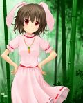  1girl akakabu_(obsidian910) animal_ears bamboo bamboo_forest blurry brown_hair carrot_necklace daisy depth_of_field dress flower forest hands_on_hips highres inaba_tewi looking_at_viewer nature outdoors pink_dress puffy_short_sleeves puffy_sleeves rabbit_ears red_eyes short_hair short_sleeves small_breasts smile solo touhou 