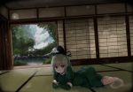  1girl dress ghost_tail green_dress green_eyes green_hair hat indoors long_sleeves looking_at_viewer lying monobe_tsukuri nature on_floor on_side parted_lips puffy_sleeves short_hair soga_no_tojiko solo tate_eboshi touhou 