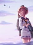  1girl airplane binoculars brown_eyes brown_hair hair_ornament hane_yoshiyumi highres kantai_collection short_hair sky yukikaze_(kantai_collection) 