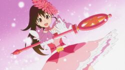  1girl :d adachi_shingo_(person) april_fools brown_eyes brown_hair cosplay creator_connection female flower flower_on_head game_cg gerbera_pink gerbera_pink_(cosplay) hair_ornament long_hair magical_flowers magical_girl official_art open_mouth ponytail servant_x_service skirt smile solo staff taneshima_popura working!! 