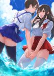  2girls akagi_(kantai_collection) black_legwear brown_eyes brown_hair from_behind fukuroumori hakama_skirt highres holding_hands japanese_clothes kaga_(kantai_collection) kantai_collection long_hair multiple_girls side_ponytail sleeves_folded_up smile tasuki thigh-highs wading white_legwear 