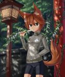  1girl androgynous animal_ears bangs bike_shorts brick_wall brown_hair dappled_sunlight dreadtie eating fox_ears fox_tail green_eyes hair_between_eyes hand_in_pocket highres ivy jacket logo original outdoors plant popsicle short_hair signature small_breasts solo tail wooden_lantern 