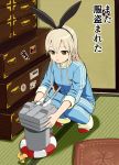  1girl alternate_costume animal_ears blonde_hair brown_eyes chest_of_drawers cushion drawer fake_animal_ears hairband indoors kantai_collection long_hair long_sleeves payot pillow propeller rabbit_ears rensouhou-chan shimakaze_(kantai_collection) shoes sleeves_pushed_up solo squatting sticker sukeroku_(treeee) tatami track_suit uwabaki 