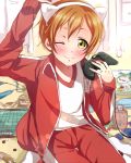  1girl animal_ears arihara_(arhr0) cat_ears controller game_controller hoshizora_rin love_live!_school_idol_project one_eye_closed orange_hair short_hair track_suit yellow_eyes 