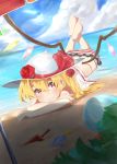  1girl ball beach beach_umbrella beachball blonde_hair blush clouds dutch_angle emushake flandre_scarlet flower grin hat hat_flower hat_ribbon highres horizon long_hair looking_at_viewer lying ocean on_stomach red_eyes red_rose ribbon rose shade side_ponytail sky smile solo swimsuit touhou wings 