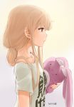  1girl blonde_hair clothes_writing dated from_side futaba_anzu hair_over_shoulder idolmaster idolmaster_cinderella_girls low_twintails nagian profile solo stuffed_animal stuffed_bunny stuffed_toy t-shirt twintails you_work_you_lose 