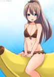  1girl akky_(akimi1127) banana_boat bikini brown_hair green_eyes highres kantai_collection kumano_(kantai_collection) long_hair ponytail sitting swimsuit 