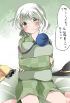  1girl checkered commentary_request green_eyes hammer_(sunset_beach) hat hat_removed headwear_removed komeiji_koishi looking_at_viewer on_bed pajamas pillow pillow_hug short_hair smile solo third_eye touhou translation_request 