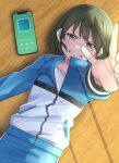  1girl bangs blue_jacket blue_pants cellphone clenched_teeth commentary_request dot_nose from_above gakuto_96 green_eyes green_hair half-closed_eyes highres idolmaster idolmaster_shiny_colors jacket long_sleeves looking_ahead lying nanakusa_nichika on_floor outstretched_hand pants phone shirt short_hair smartphone solo sweat tearing_up tears teeth track_jacket v-shaped_eyebrows white_shirt wooden_floor 