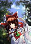  1girl absurdres armband ascot blue_sky bow brown_eyes brown_hair bush dappled_sunlight detached_sleeves forest frilled_bow frilled_collar frills gohei hair_bow hair_tubes hakurei_reimu hand_up highres hoshino_arika long_hair looking_to_the_side nature ribbon-trimmed_sleeves ribbon_trim sky sleeveless smile solo touhou tree tree_shade upper_body 