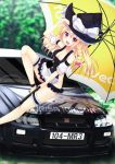  1girl :d blonde_hair bottomless breasts brown_eyes character_name cleavage fang hat holding_umbrella kirisame_marisa large_breasts long_hair looking_at_viewer nissan_skyline open_mouth smile solo touhou witch_hat yaki_mayu 
