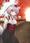  1girl animal_ears arms_behind_back autumn autumn_leaves bridge detached_sleeves hat inubashiri_momiji kourindou_tengu_costume leaning_over looking_to_the_side obi red_eyes sash sayama_(chiwan0830) smile solo tail tokin_hat touhou water waterfall white_hair wolf_ears wolf_tail 