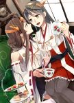  2girls ahoge bare_shoulders black_hair black_tea blue_eyes brown_hair cake camel000 clock couch cup detached_sleeves food fork hair_bun hair_ornament hair_rings hairclip haruna_(kantai_collection) headgear indoors japanese_clothes kantai_collection kettle kongou_(kantai_collection) lips long_hair long_sleeves looking_at_another multiple_girls nontraditional_miko red_eyes remodel_(kantai_collection) ribbon-trimmed_sleeves ribbon_trim sitting sitting_on_lap sitting_on_person skirt smile sofawindow tea teacup thigh-highs 