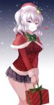  1girl asle bell_hair_ornament blue_eyes blue_skirt blush bow bowtie capelet christmas fur_trim green_bow green_bowtie hands_together hat holding_gift kantai_collection kashima_(kantai_collection) long_sleeves looking_at_viewer pleated_skirt santa_hat short_hair silver_hair simple_background skirt smile snowflakes snowing solo standing sweater two_side_up v_arms 