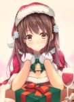  1girl bell blurry blush box breasts brown_eyes brown_hair capelet cleavage cup depth_of_field drinking_glass flower gift gift_box gintarou_(kurousagi108) gloves hair_flower hair_ornament hat long_hair looking_at_viewer original red_gloves santa_costume santa_hat smile solo wine_glass 