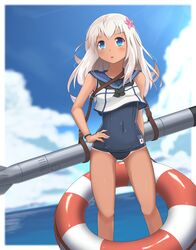  1girl blonde_hair blue_eyes crop_top flower hair_flower hair_ornament hand_on_hip highres insolent_skwid kantai_collection lifebuoy long_hair one-piece_tan ro-500_(kantai_collection) sailor_collar school_swimsuit standing swimsuit swimsuit_under_clothes tan tanline torpedo 