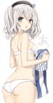  1girl ass blue_eyes bra breasts employee_uniform hat highres holding_clothes kantai_collection kashima_(kantai_collection) komeshiro_kasu lawson long_hair looking_back open_mouth panties shirt silver_hair solo teeth twintails underwear underwear_only uniform 