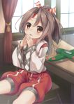  1girl aircraft airplane blush brown_eyes brown_hair chair curtains ezoshika_gg hachimaki headband high_ponytail japanese_clothes kantai_collection long_hair looking_at_viewer muneate open_mouth ponytail shorts sitting smile solo table tassel window zuihou_(kantai_collection) 