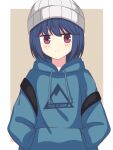  1girl bangs beanie beige_background blue_hair blue_hoodie blush border closed_mouth clothes_writing commentary copyright_name expressionless eyebrows_visible_through_hair hands_in_pockets hat highres hood hood_down hoodie jitome looking_at_viewer medium_hair outside_border print_hoodie shima_rin simple_background solo upper_body violet_eyes white_border white_headwear yurucamp zeta_(24904340) 