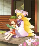  2girls animal_ears blonde_hair blue_eyes book brown_eyes brown_hair cat_ears cat_tail chen eijima_moko flower fox_tail hat highres long_sleeves multiple_girls multiple_tails open_mouth pillow_hat reading ribbon short_hair sitting sitting_on_lap sitting_on_person socks tail tassel touhou white_legwear wide_sleeves yakumo_ran 