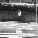  1girl bag bow bowtie bush day full_body handbag holding_bag ilya_kuvshinov kneehighs loafers long_hair looking_at_viewer looking_to_the_side monochrome original outdoors pavement plant pole potted_plant road road_sign shoes sign solo standing street sunlight sweater 