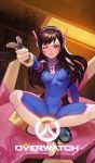  1girl :d bangs bodysuit breasts brown_eyes brown_hair bunny_print chain copyright_name d.va_(overwatch) facial_mark finger_gun gloves grin hand_up headphones high_collar highres holding indian_style lim_jaejin lips lipstick logo long_hair makeup mecha one_eye_closed open_mouth overwatch pink_lips pointing rabbit sitting smile solo whisker_markings 